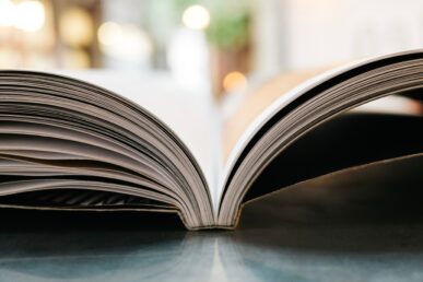 An open book lying on a library table