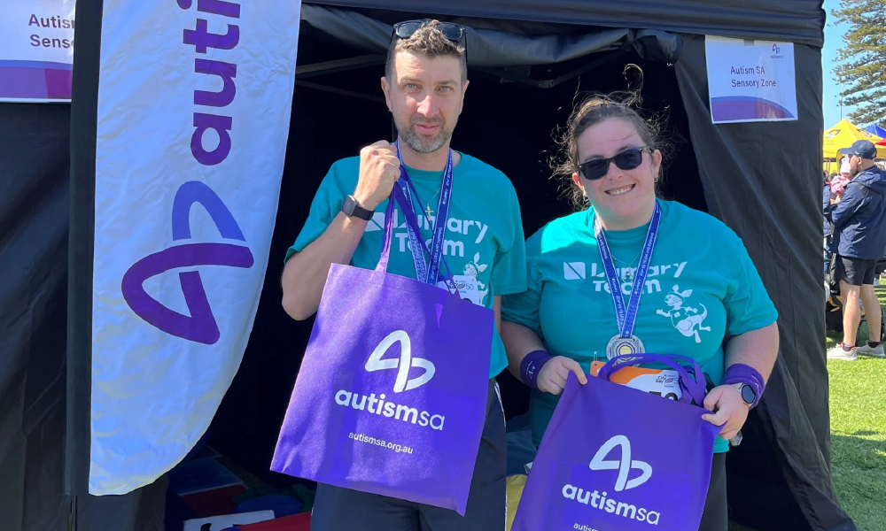 two people from the Autism SA team in front of the Sensory Zone at City-Bay 2024.