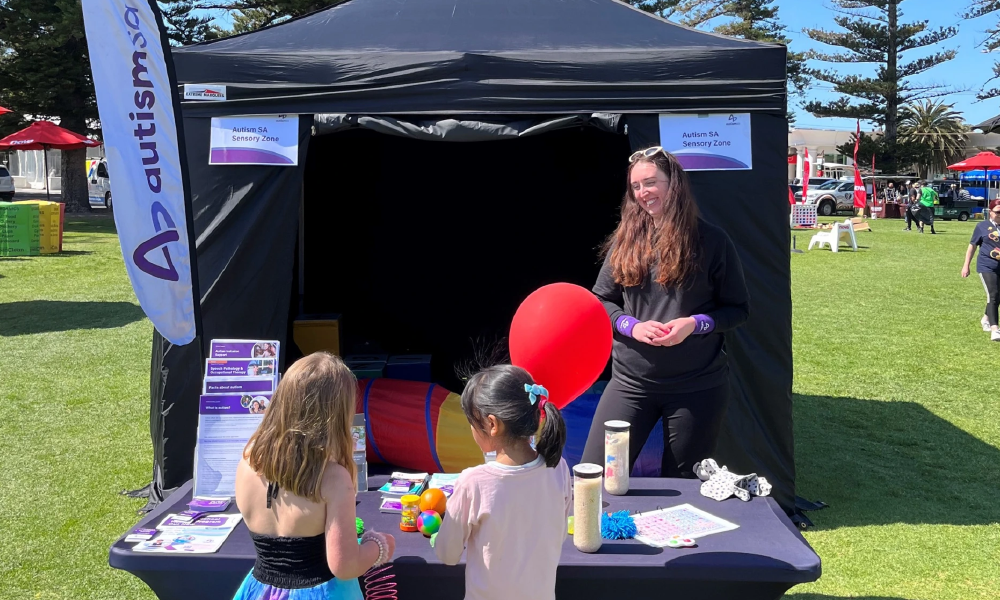 two people from the Autism SA team in front of the Sensory Zone at City-Bay 2024.