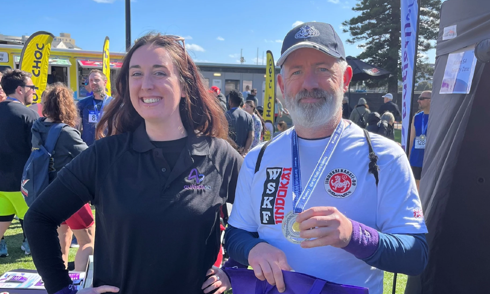 two people from the Autism SA team in front of the Sensory Zone at City-Bay 2024.